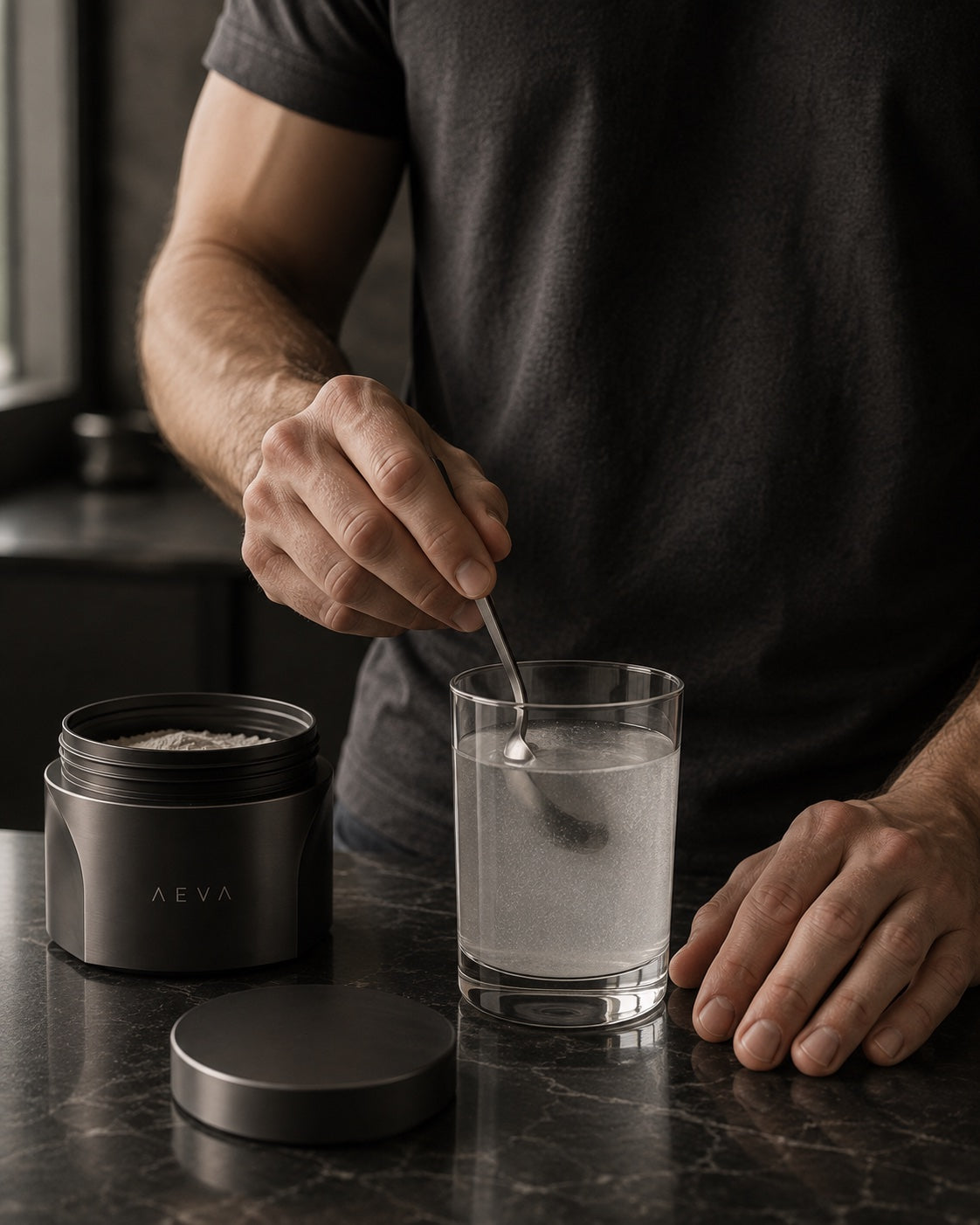 Preparing a glass of creatine, with the AEVA jar close at hand